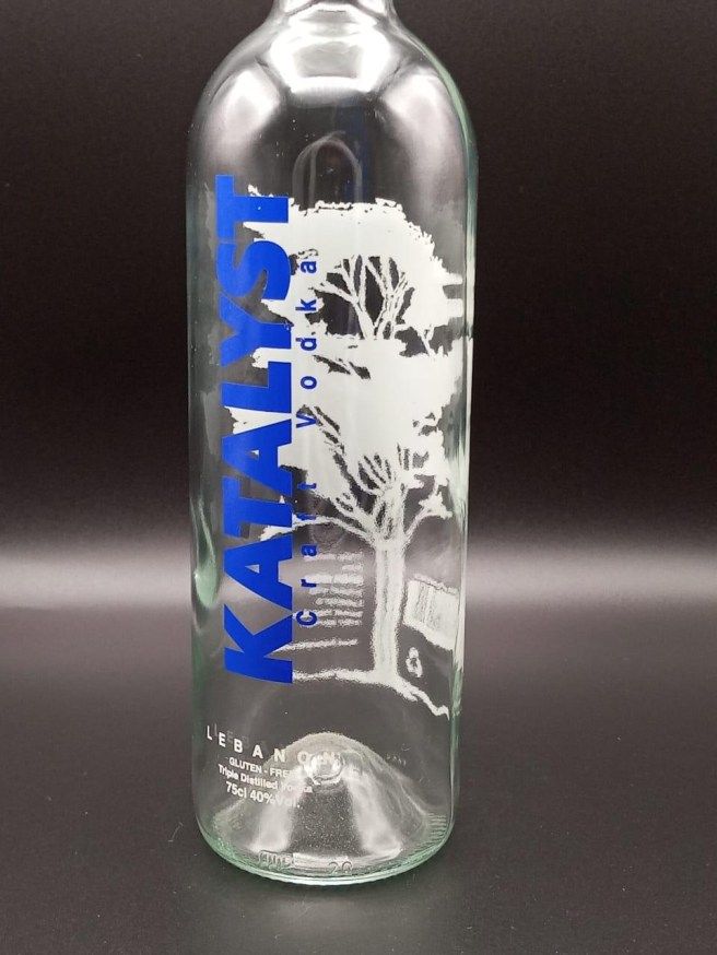 Katalyst vodka bottle with blue and white print